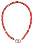 Necklace with red beads and silver clasp on a white background