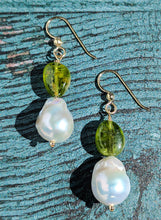 Load image into Gallery viewer, Peridot and Baroque Pearl earrings on 14 Karat gold earring wire. The dangle earrings measure 2&quot;.