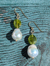 Load image into Gallery viewer, Peridot and Baroque Pearl earrings on 14 Karat gold earring wire. The dangle earrings measure 2&quot;.