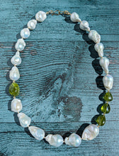 Load image into Gallery viewer, Baroque pearl, peridot and gold necklace measuring 19&quot;. The peridots are offset with three on one side of the necklace and one larger peridot on the opposite side.  Between each pearl and peridot gem are 14 Karat gold beads and the necklace is finished with a 14 Karat hook and eye clasp.