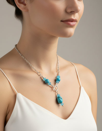 Turquoise and silver toggle necklace on a model.