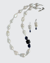 Load image into Gallery viewer, Baroque Pearl and Sapphire necklace and matching earrings. The necklace has a sterling silver heart clasp and the earrings are designed with sterling silver  French hook earring wire.