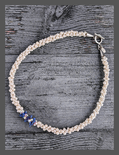 &quot;Something Blue&quot; necklace is a combination of glowing cultured freshwater pearls with center stones in gorgeous lapis lazuli and sparkly Swarovski crystals. The beads are braided on 8 strands to create an elegant heirloom-quality necklace 