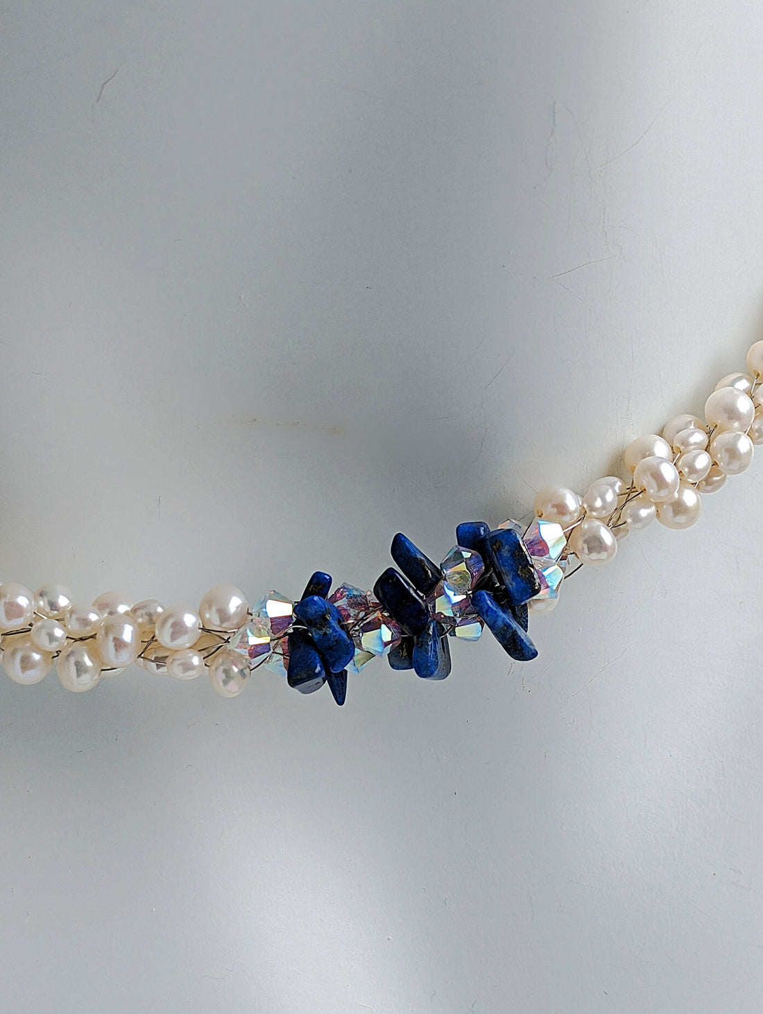 &quot;Something Blue&quot; necklace is a combination of glowing cultured freshwater pearls with center stones in gorgeous lapis lazuli and sparkly Swarovski crystals. The beads are braided on 8 strands to create an elegant heirloom-quality necklace 