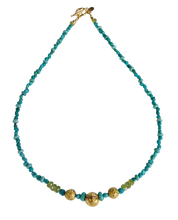 Load image into Gallery viewer, necklace with 24-Karat gold leaf on three round lava stones for centerpiece surrounded by turquoise beads, faceted peridot beads, and 14-Karat gold-filled Toggle Clasp along with designer signature tag