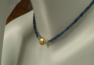 4mm sparkly faceted dark blue onyx, faceted aqua apatite, and gold gilded lava stone Necklace close up on mannequin neck