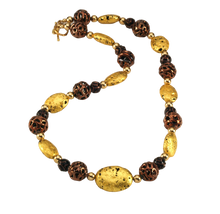 Load image into Gallery viewer, Hand made necklace with 23 karat gold gilded lava stones, lamp work bronze Czech glass, and 14 karat gold filled small round beads. The necklace is finished with 14 karat gold filled toggle clasp.