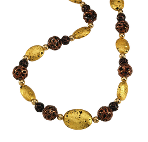 Close up of Hand made necklace with 23 karat gold gilded lava stones, lamp work bronze Czech glass, and 14 karat gold filled small round beads.