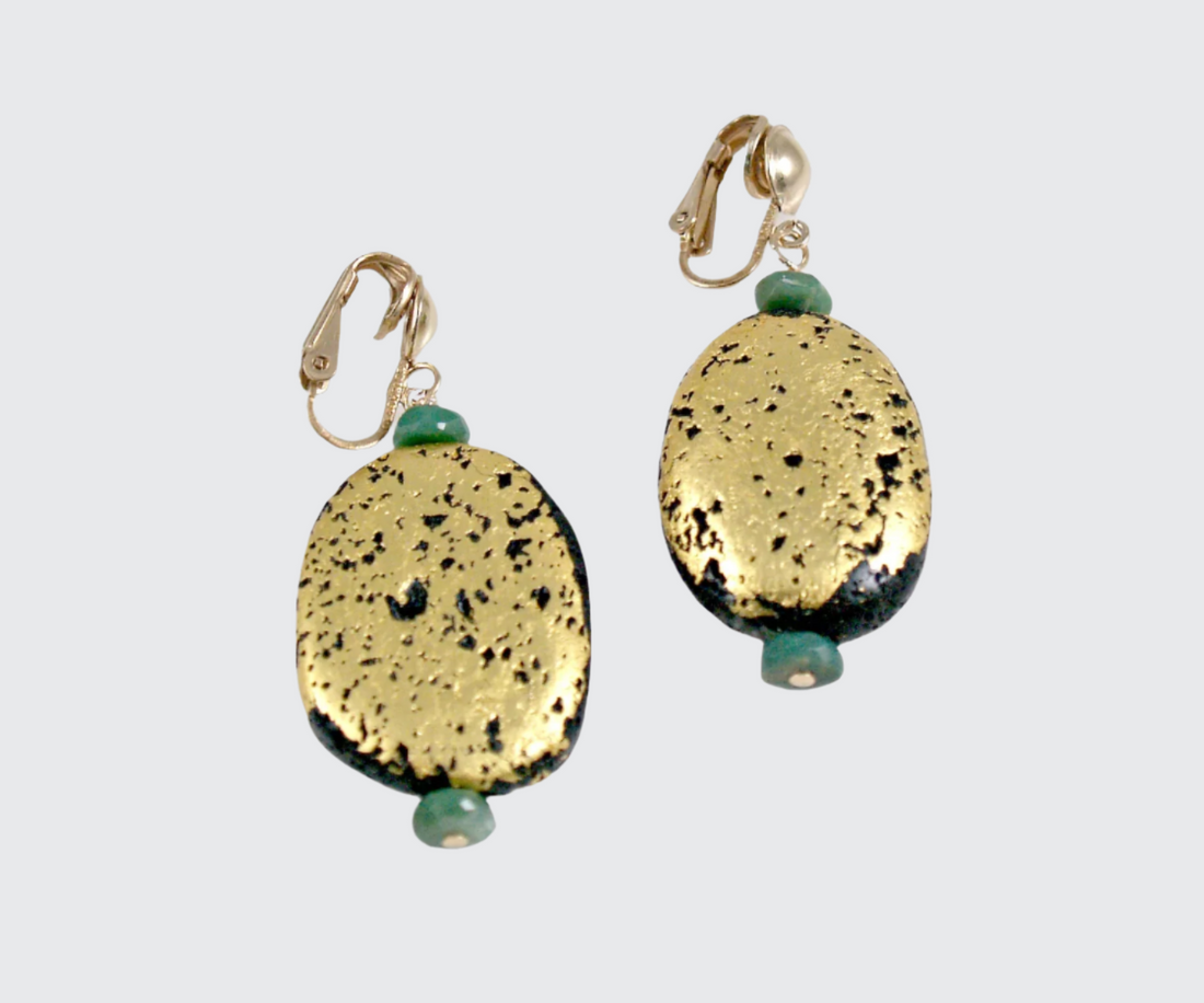 A pair of clip earrings featuring a gilded gold lava stone with green chrysoprase accents.