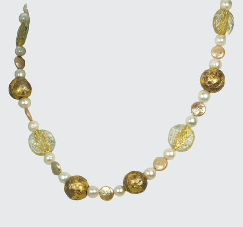 Pearl necklace with gold gilded beads, gold lampwork Czech glass beads, featured on a mannequin neck.