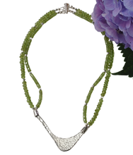 Load image into Gallery viewer, Hammered silver abstract pendant necklace with two strands of peridot and silver beads. The necklace is finished with a magnetic clasp and the artist&#39;s signature tag. The necklace measures 17&quot; (43.18cm)
