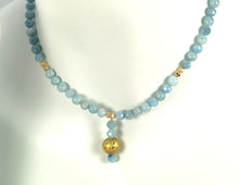 Load image into Gallery viewer, aquamarine and gold gilded round lava pendant necklace on model