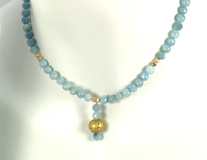aquamarine and gold gilded round lava pendant necklace on model